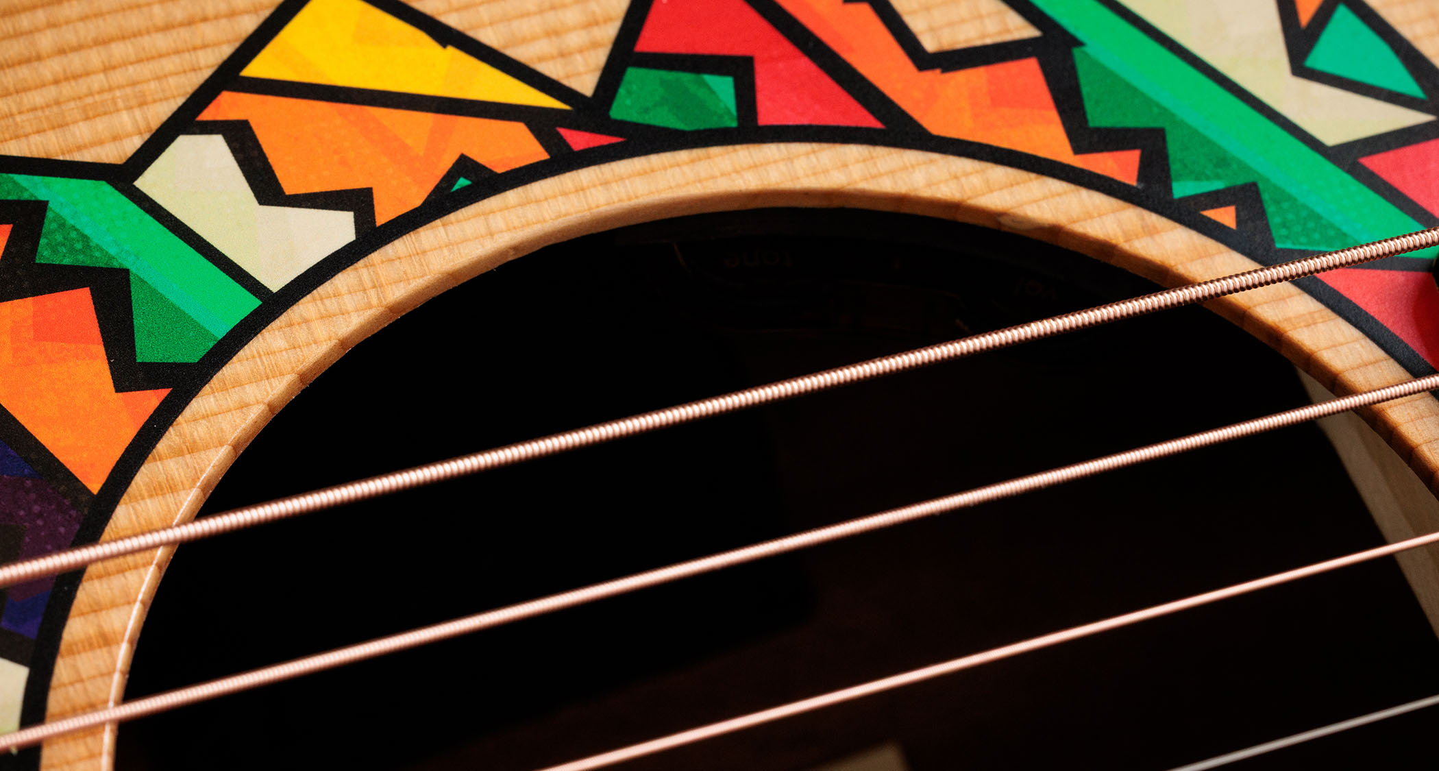 Taylor Jacob Collier GS Mini: featuring a brightly-coloured rosette graphic designed with the musical polymath, this beginner friendly acoustic has a bold five-string design for his signature DAEAD tuning.