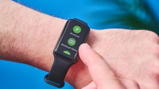 a small fitness tracker with a smooth touchscreen and TPU strap and a bright, vibrant screen showing activity types and a heart rate monitor on the underside