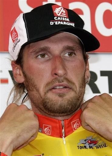 Karpets straightens up his yellow jersey.