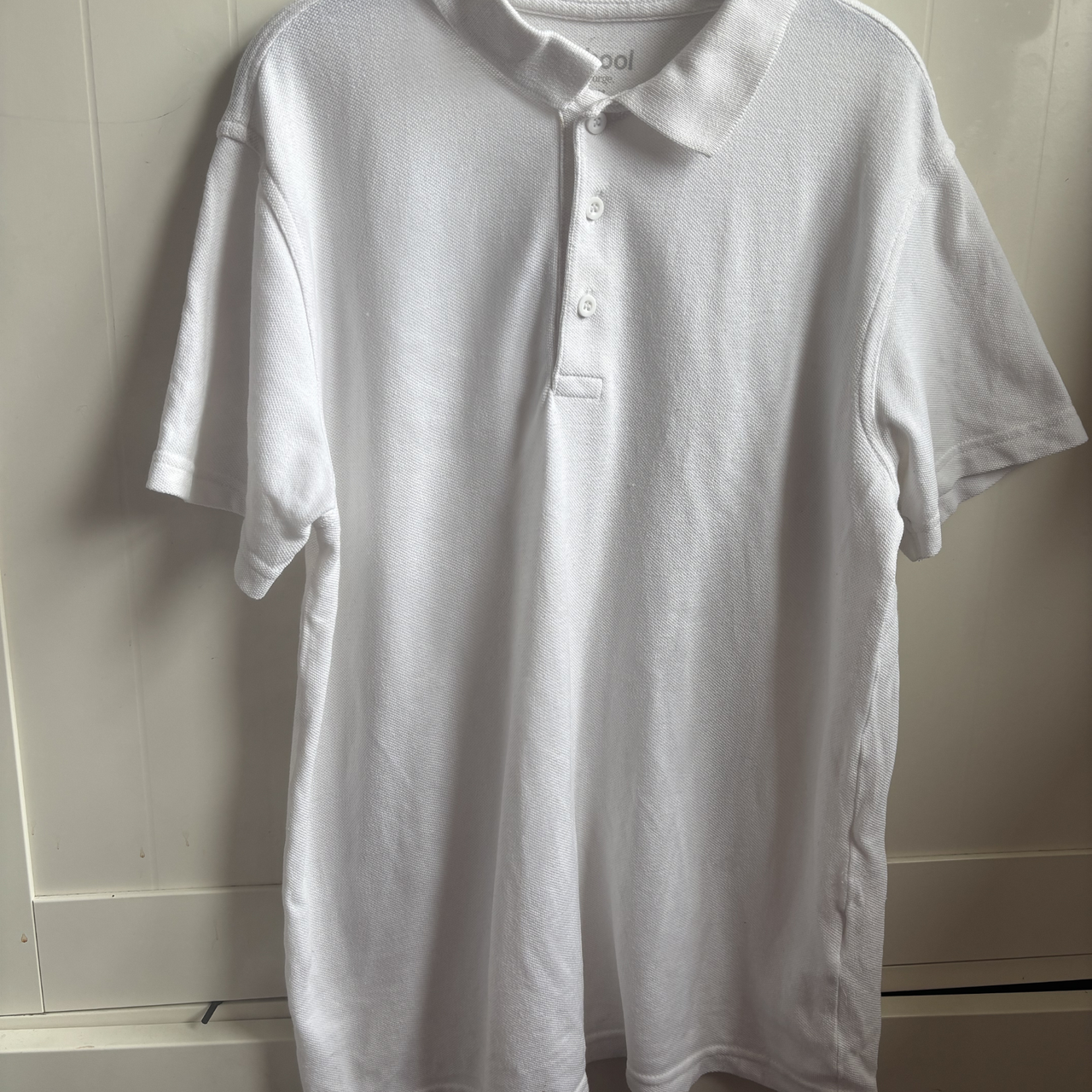 White polo shirt after using the Beldray Digital Handheld Steam Cleaner upholstery attachment to steam clothes