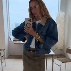 Woman in denim jacket and plaid skirt