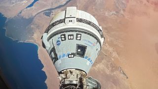 A photo showing the Boeing Starliner in orbit above the Earth