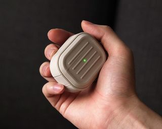 elago Armor AirPods case being held in man's hand