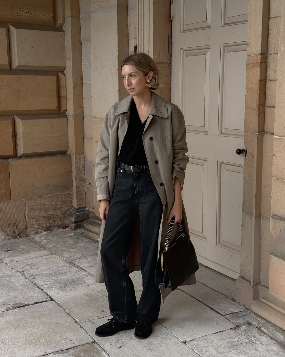 @brittanybathgate wearing a trench coat and jeans