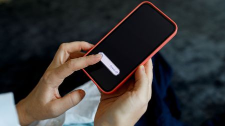 Woman's hands turning off mobile phone 