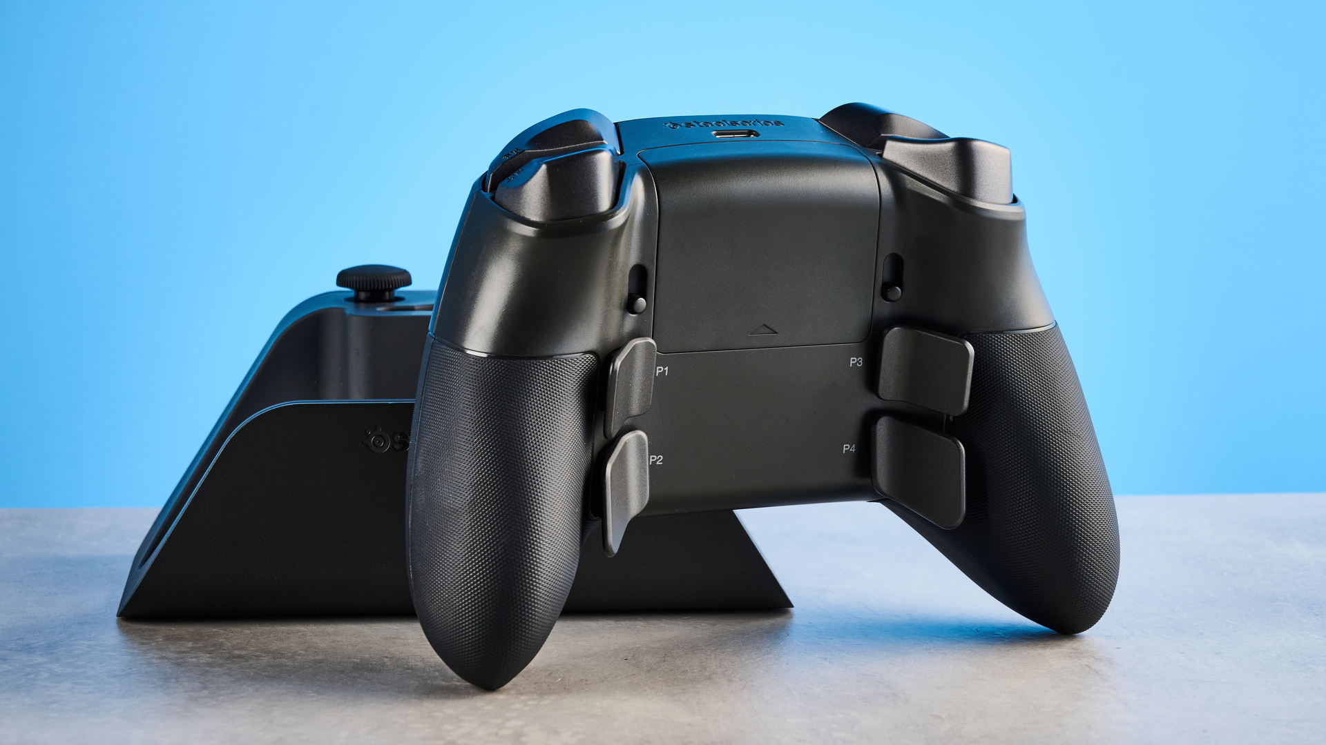 The SteelSeries Aeon Pro on a stone surface against a blue background