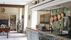 How We Test Cookware: A French country kitchen with hanging copper pans