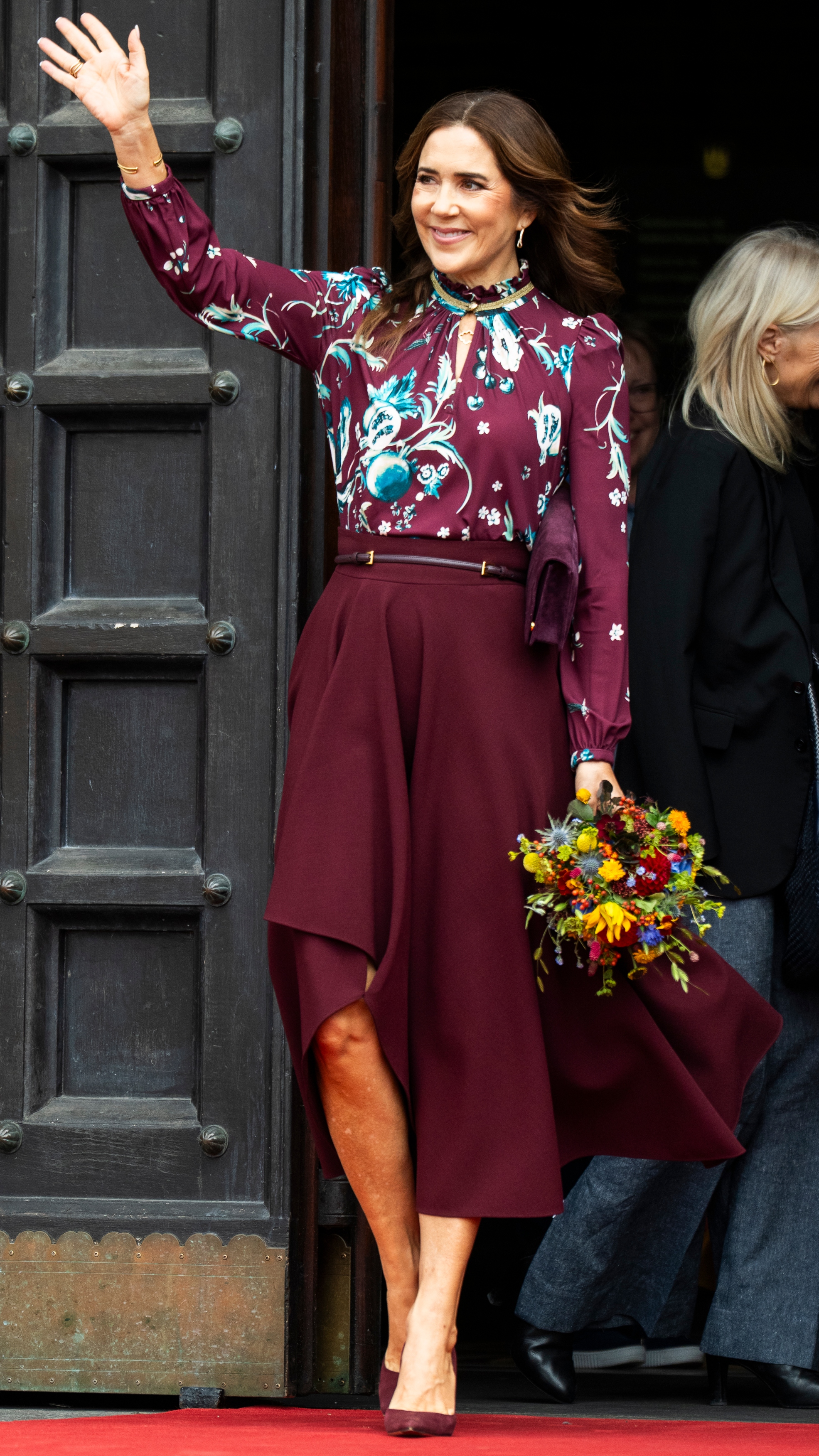 Queen Mary of Denmark waves as she attends the presentation of the 2025 Christmas stamp on October 6, 2025