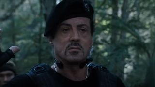 Sylvester Stallone outside with trees in The Expendables 2