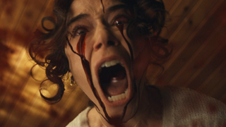 Tatiana Maslany screaming with blood in her eyes in The Monkey