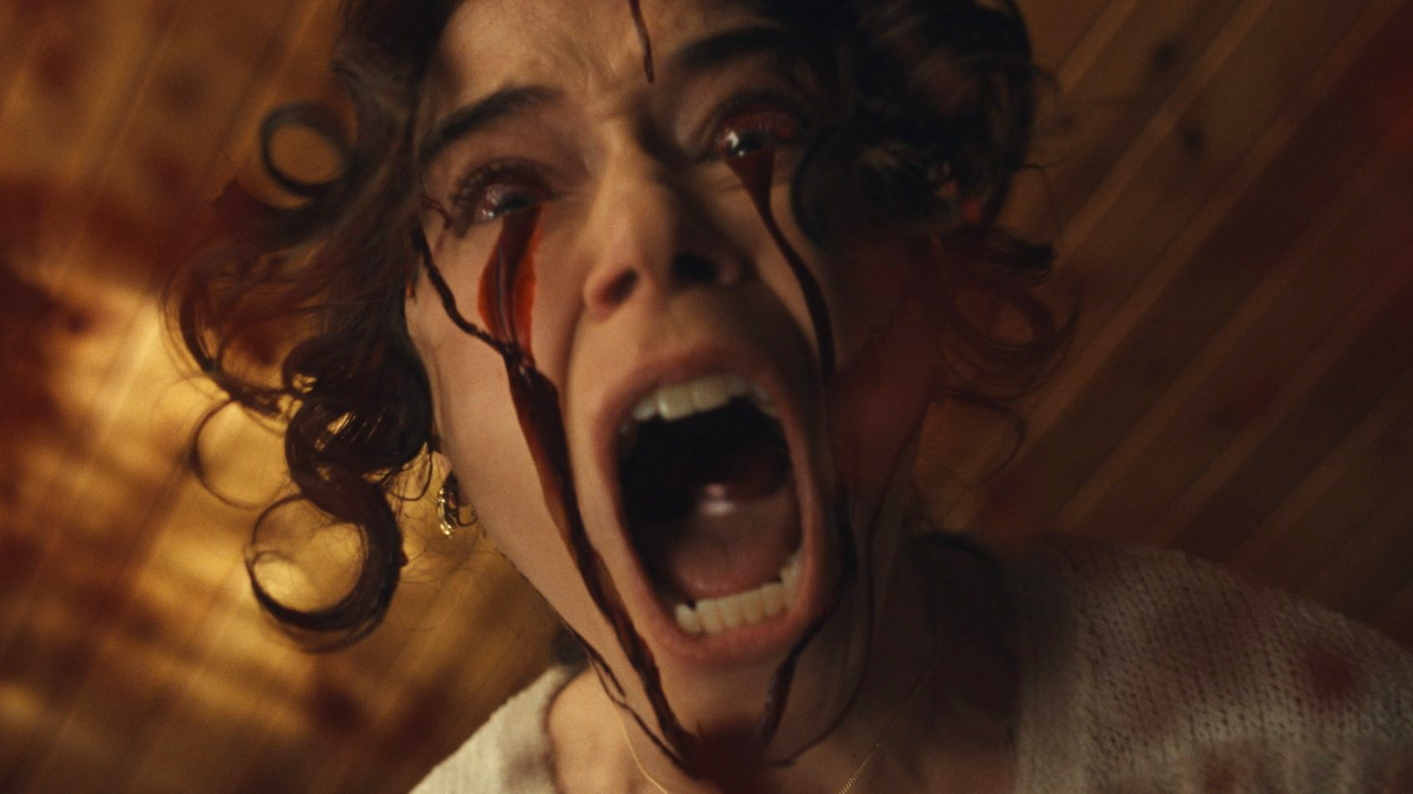 Tatiana Maslany screaming with blood in her eyes in The Monkey