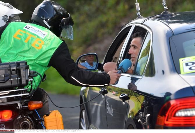 Miguel Indurain gives a mid-race interview from his car