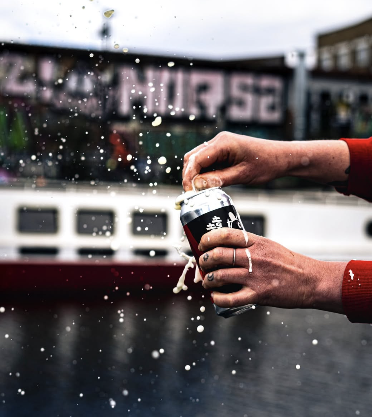 an image of a can of Howling Hops being cracked open outside the view from the taproom