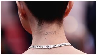 Selena Gomez's roman numeral neck tattoo, pictured as she attends the opening ceremony and screening of "The Dead Don't Die" during the 72nd annual Cannes Film Festival on May 14, 2019 in Cannes, France.