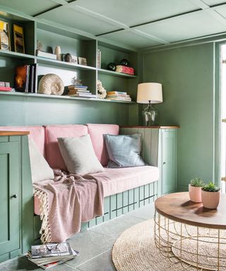 Snug room with built in banquette seating and painted green ceiling