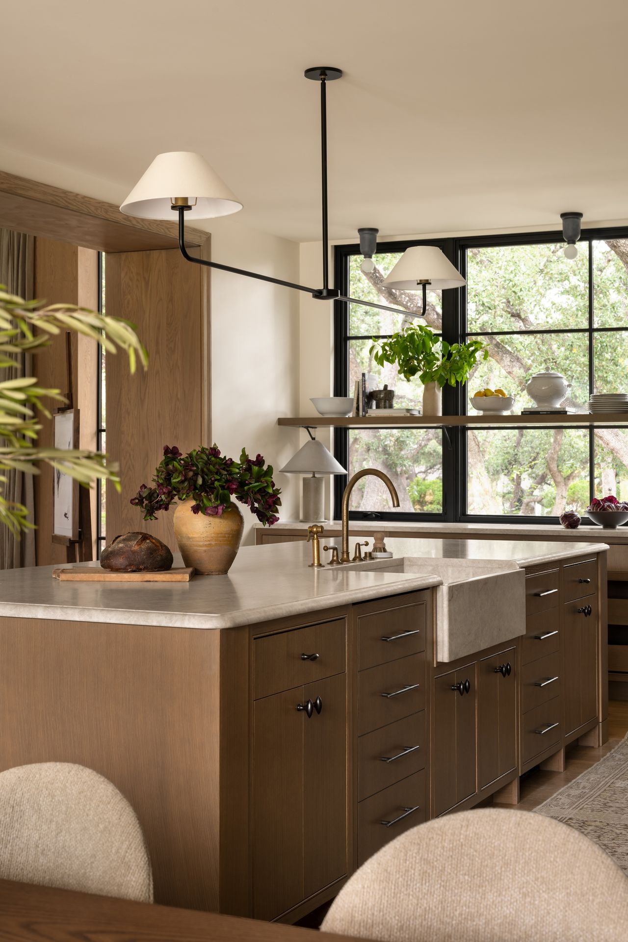 A blocky kitchen island with a farmhouse-style sink