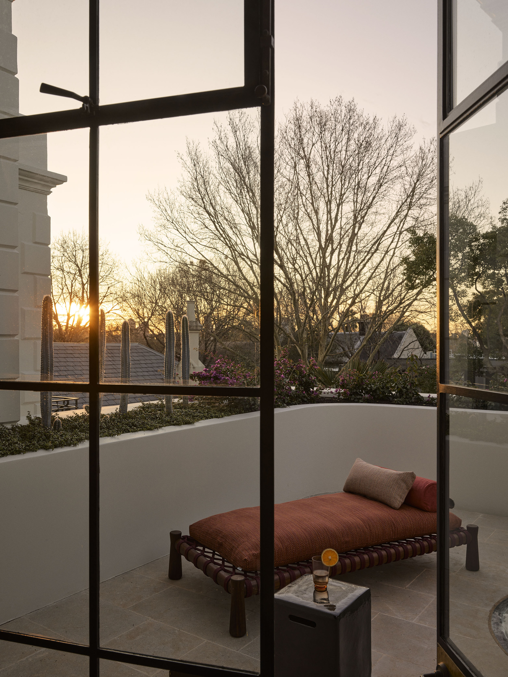 a low lounge chair on a balcony