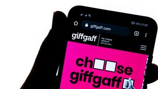 The silhouette of a user accessing Giffgaff services on a smartphone against a white background
