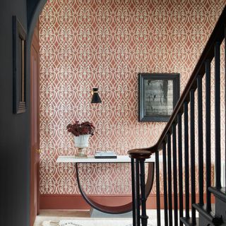 Hallway with patterned wallpapered wall combined with grey painted woodwork