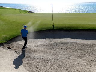 Andy Sullivan hitting a shot towards the green from a greenside bunker