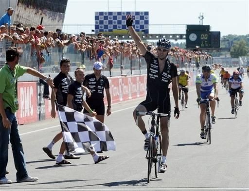 Frenchman Cyril Masson crosses the finish line as the first 24 Heures du Mans endurance cycling race winner.