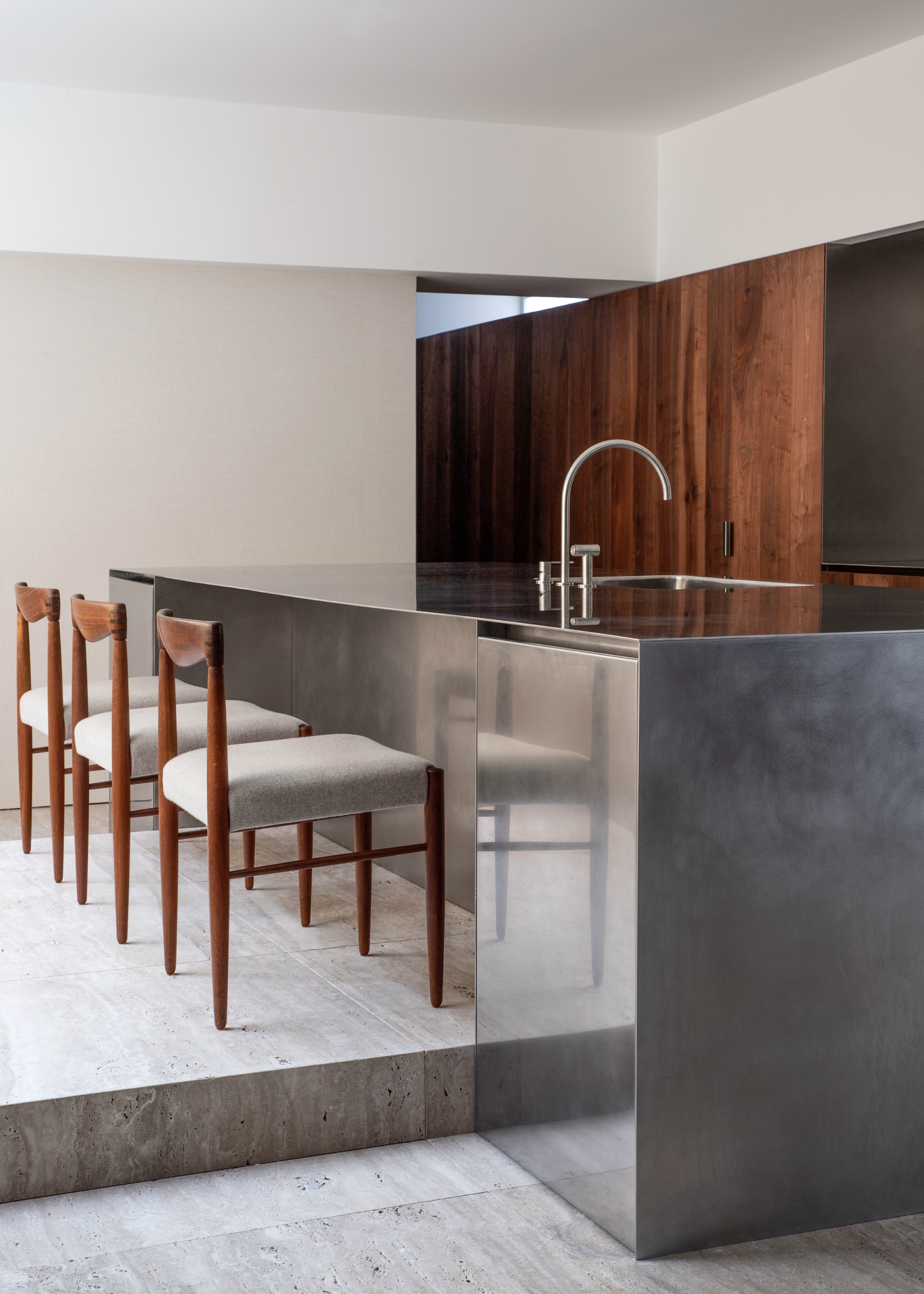 A kitchen with a fully stainless steel island