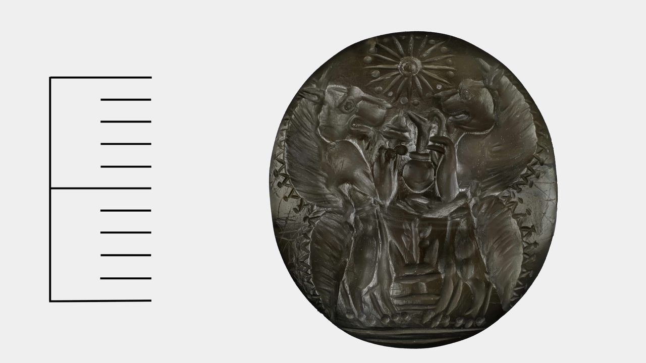 This agate sealstone depicts two lion like creatures called &ldquo;genii&rdquo; who are shown standing upright on clawed feet. The lions are carrying an incense burner and serving vase which they are giving as tribute to an altar that has a sapling tree and two horns on it. Above the lions is a 16 point star.