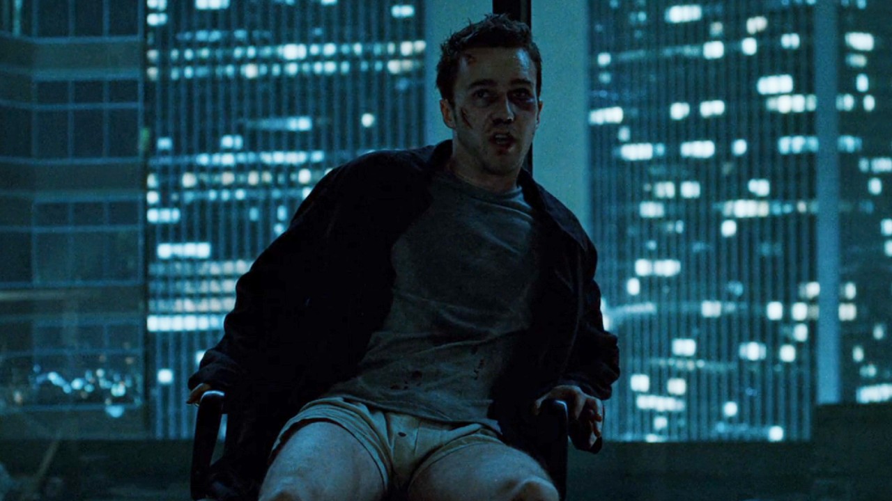 Edward Norton sitting in a chair looking scared in the last scene of Fight Club.