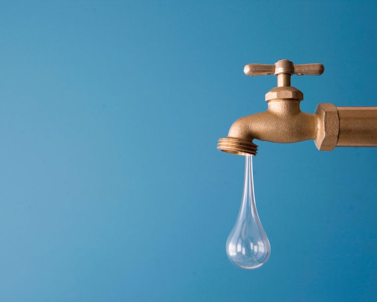 leaky faucet against blue backdrop