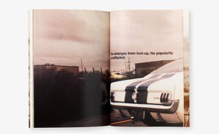 Book spread open, image of a white car with black centre stripes driving on a road, cloudy sky and surrounding landscape at the side of the road