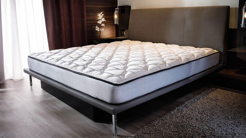 The Marriott bed foam mattress on a bed frame in a hotel room