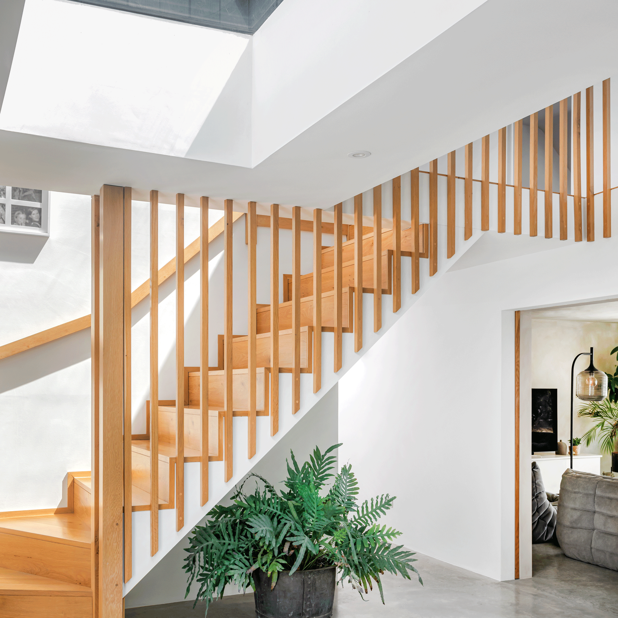 modern hallway with timber staircase and balustrade