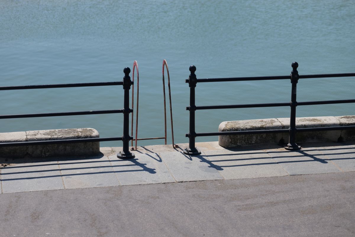 Steps leading down off a pier into the ocean