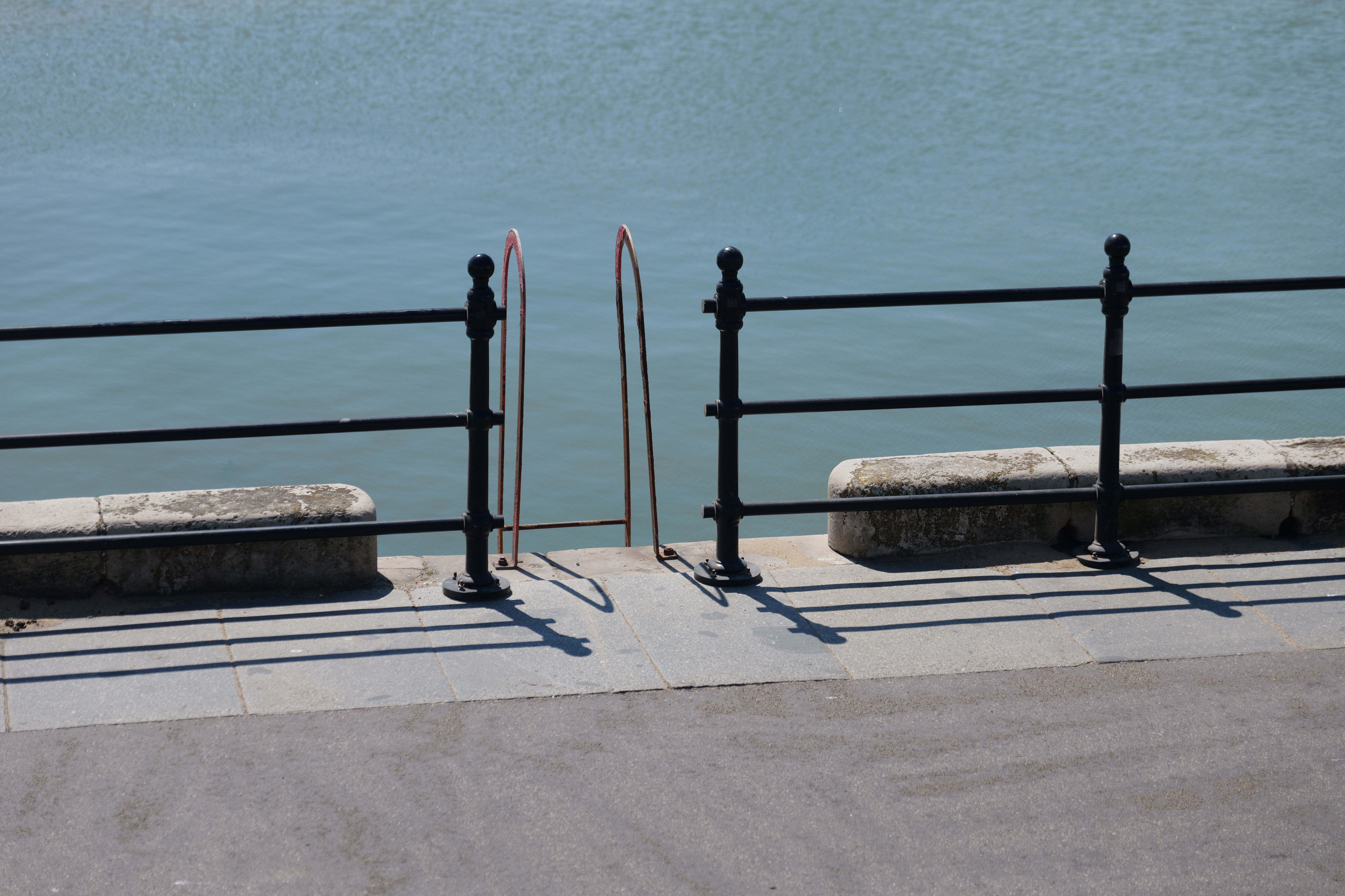 Steps leading down off a pier into the ocean