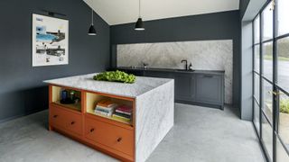 kitchen with orange island and marble tops