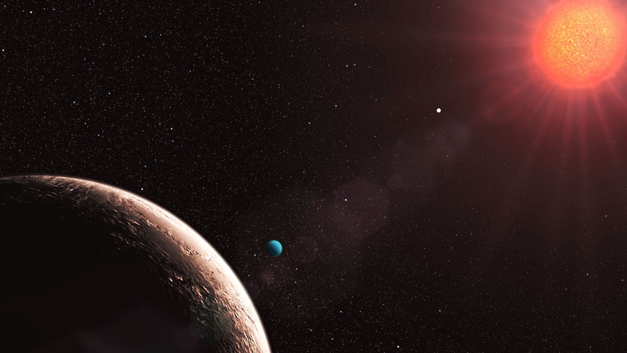 Exoplanet Gliese 581e in the foreground of this artist's illustration is part of the Gliese 581 planetary system.