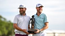 Joe Greiner (left) and Justin Thomas hold up the RBC Heritage trophy after their win in 2025