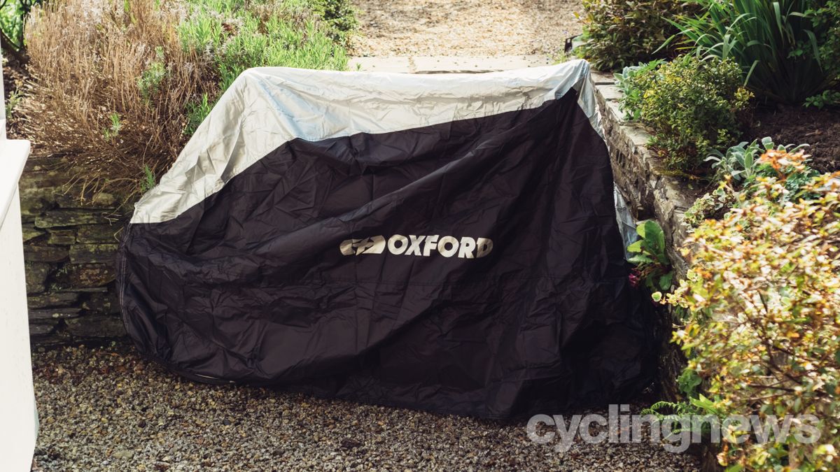A bike covered in a black and silver cover