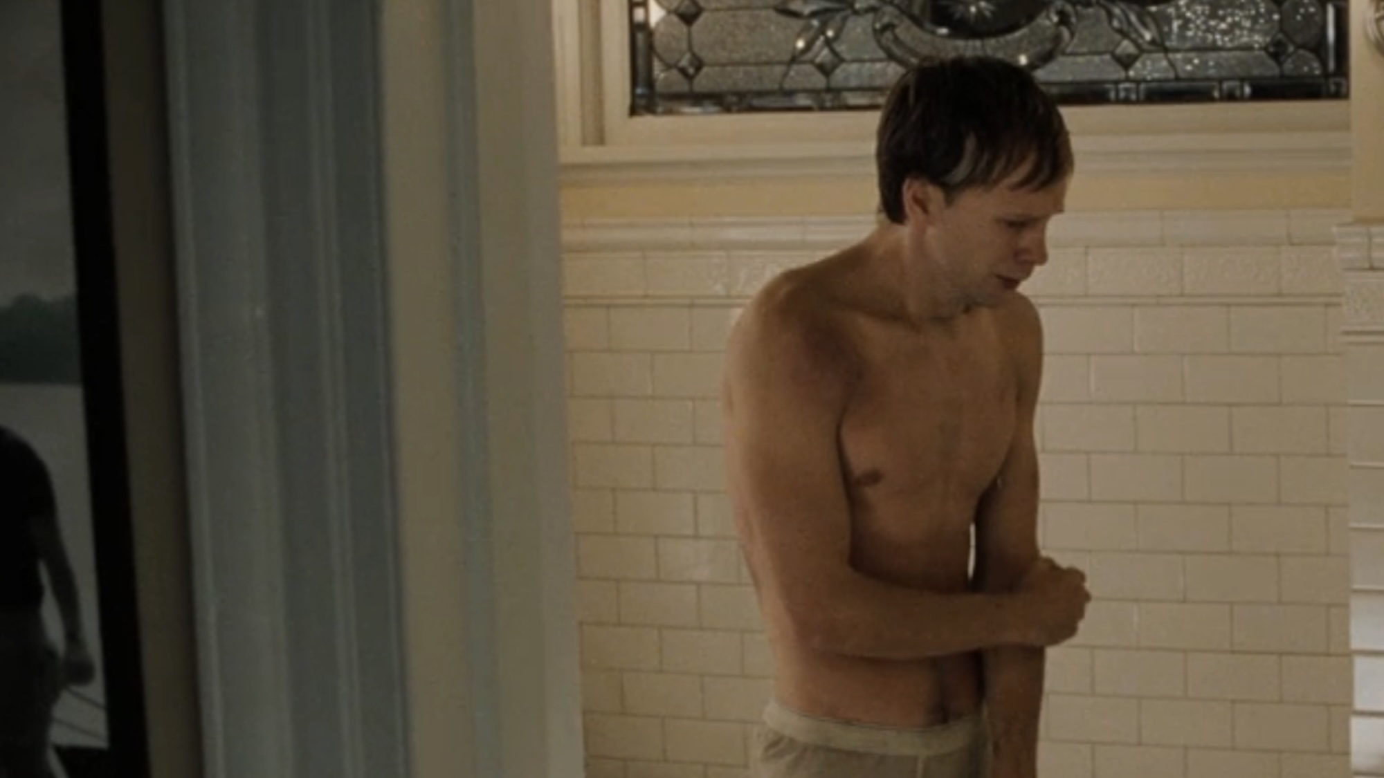 Donnie Wahlberg standing scared in a bathroom in The Sixth Sense