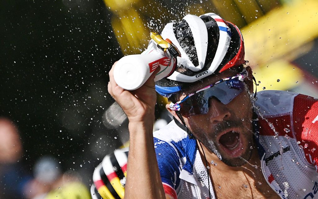 Team GroupamaFDJ rider Frances Thibaut Pinot refresh himself as he climbs during the fifth stage of the 72nd edition of the Criterium du Dauphine cycling race 153 km between Megeve and Megeve on August 16 2020 Photo by AnneChristine POUJOULAT AFP Photo by ANNECHRISTINE POUJOULATAFP via Getty Images