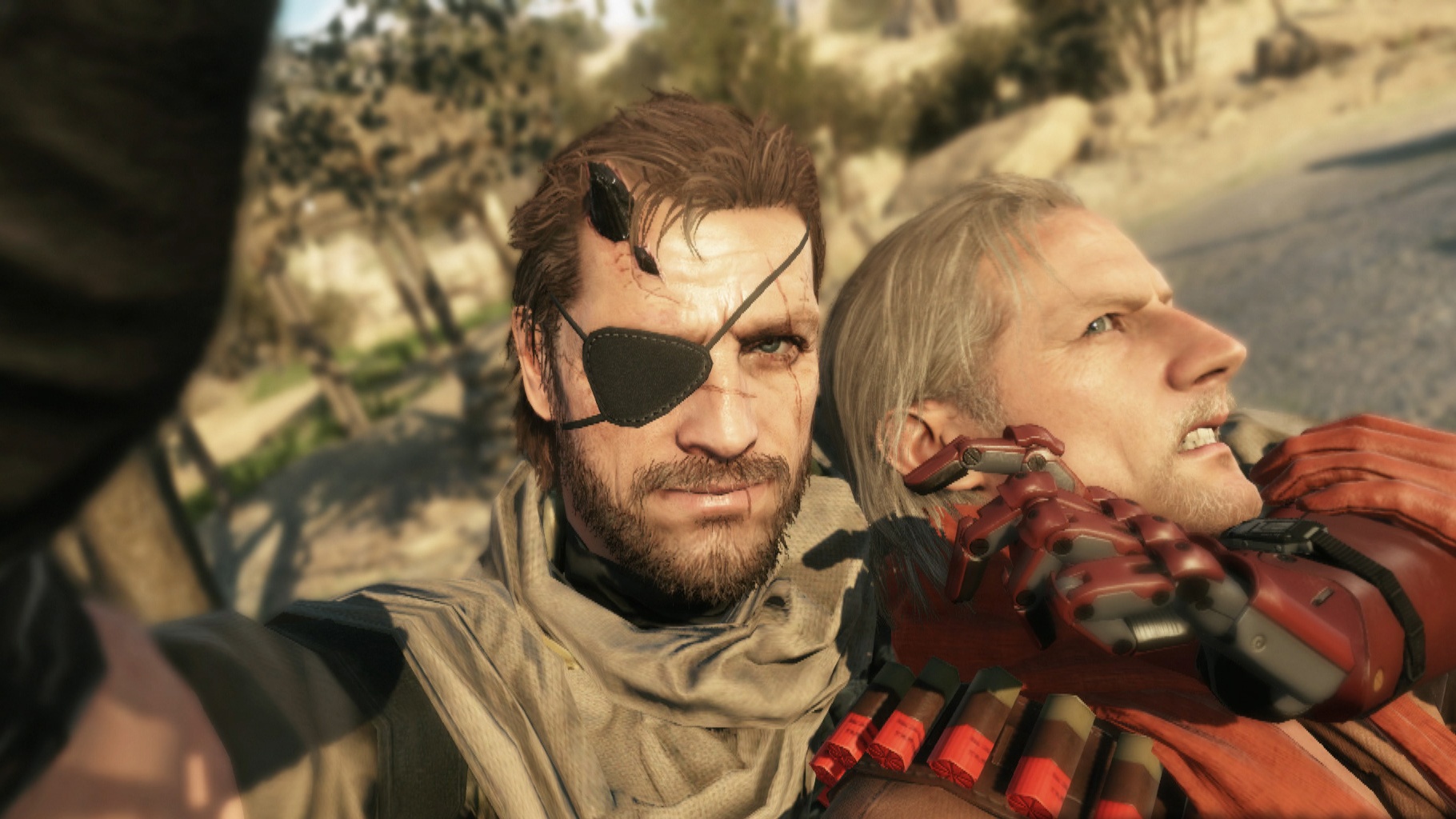 Venom Snake holds Ocelot in a headlock and takes a selfie.