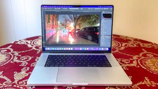 MacBook Pro 2021 (16-inch) review unit on a table, showing an HDR image