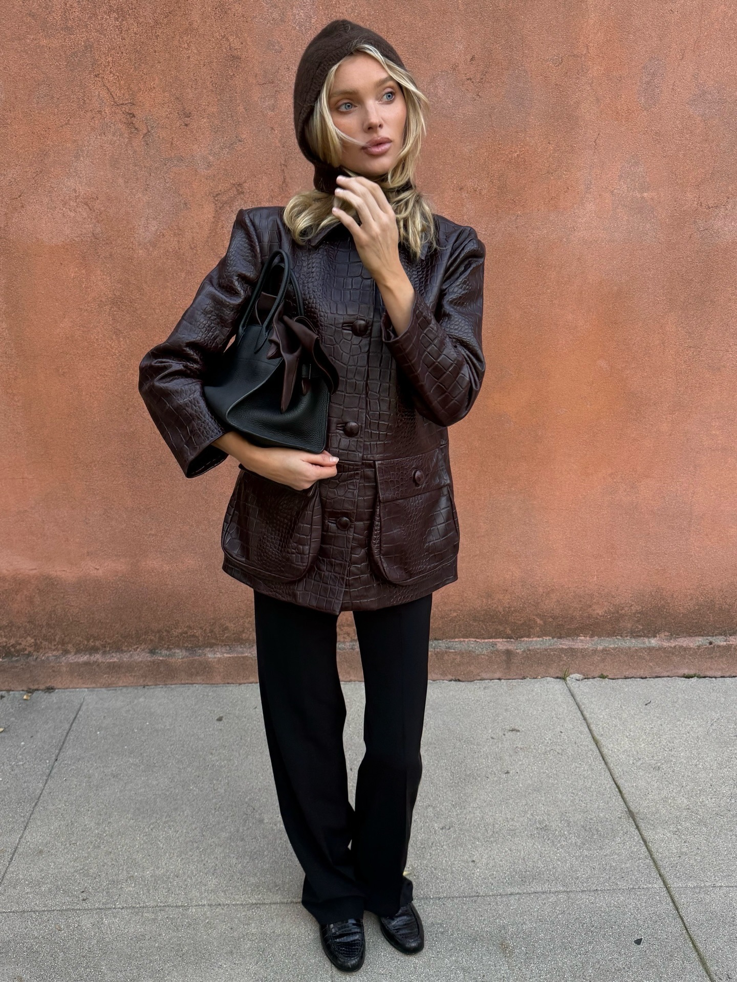 Woman wearing croc jacket, a very big spring 2026 jacket trend.