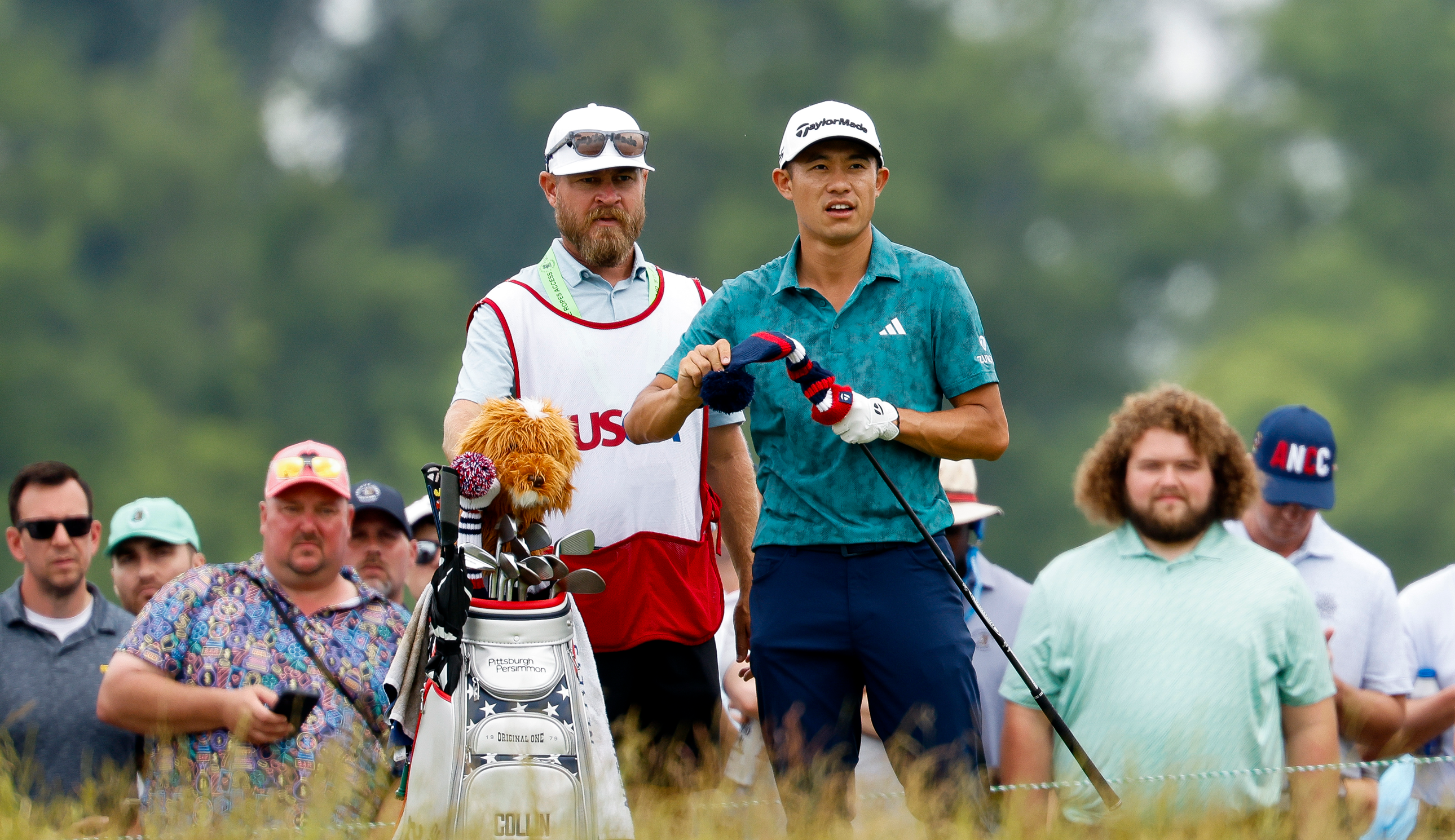 Collin Morikawa takes his headcover off his driver