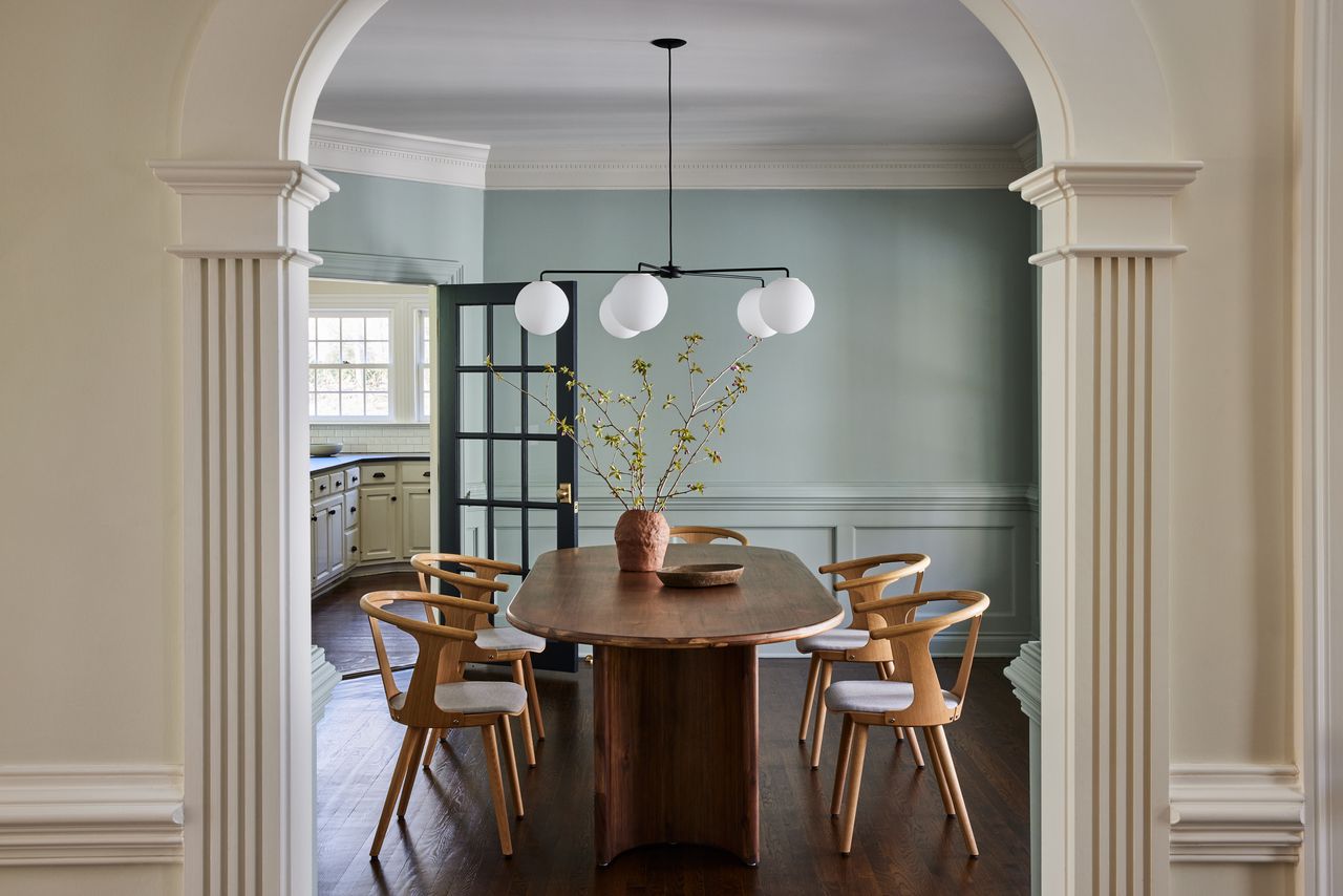 A dining room and arch in contrasting tones