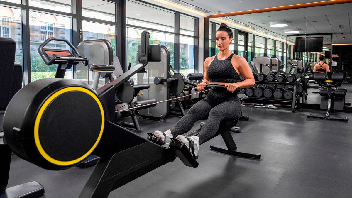 Woman using rowing machine in hotel gym