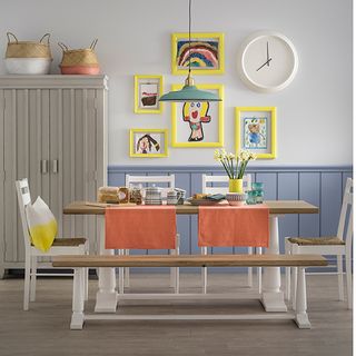 dining room with wall clock on wall and dining table with chairs