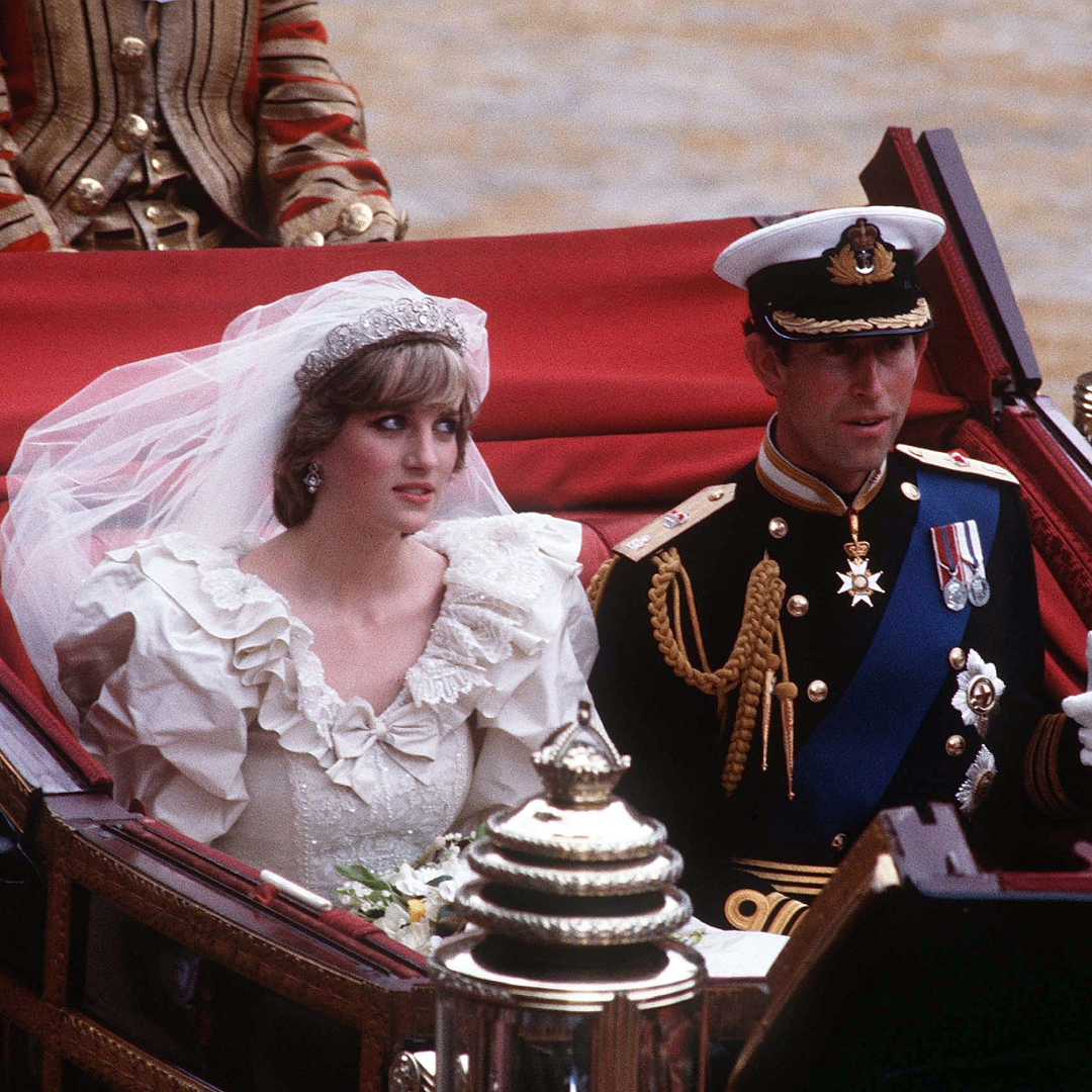 Prince Charles and Princess Diana riding in a carriage on their wedding day