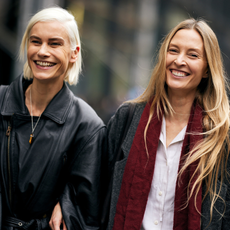 two mature women with bare skin wearing black jackets