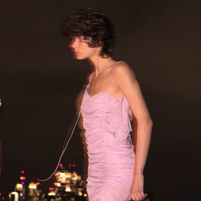 a model wearing a ruched supriya lele for mango dress